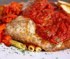 Parmigiana Platter: a little of everything, chicken, veal, eggplant, meatball, roasted red peppers and provolone over pasta