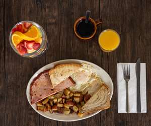 Two Extra Large Eggs, Thick Sliced Ham, Two Eggs served with a Fruit Cup, Orange Juice, and Eggs